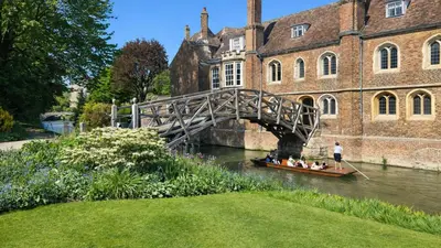 a group of people in a boat in the water under a bridge at Cambridge - Modern 4-BR Home with Gardens & Wi-Fi in Cambridge