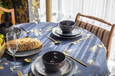 a table with a blue table cloth with dishes on it at Luxury 2 Bed Manor House With Hot Tub, Cinema Room, Sky TV in Saffron Walden