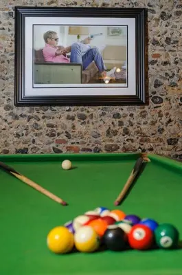 a picture of a pool table with balls and cues at Luxury 3 Bed Manor House With Hot Tub, Cinema Room, Sky TV in Saffron Walden