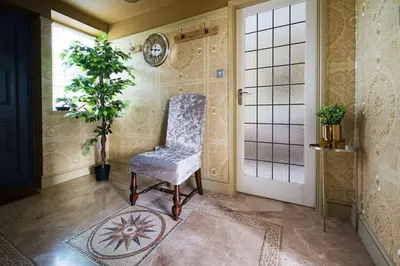 a room with a chair and a plant and a door at Deluxe 2 or 3 bed Cinema Games Room Pool Table Hot Tub in Great Sampford