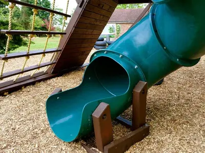 a blue slide on a playground in a yard at Deluxe 2 or 3 bed Cinema Games Room Pool Table Hot Tub in Great Sampford