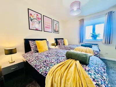 a bedroom with two beds and a window at Hidden Gem in Chelmsford by Artisan Stays I Weekly or Monthly Stay Offer I Free Parking I Sleeps 5 in Chelmsford