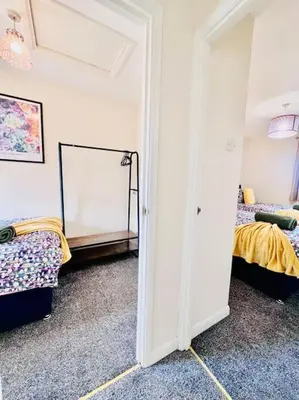 a bedroom with two beds and a mirror at Hidden Gem in Chelmsford by Artisan Stays I Weekly or Monthly Stay Offer I Free Parking I Sleeps 5 in Chelmsford