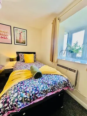 a bedroom with a bed and a window at Hidden Gem in Chelmsford by Artisan Stays I Weekly or Monthly Stay Offer I Free Parking I Sleeps 5 in Chelmsford