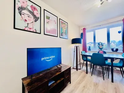 a living room with a television and a dining room table at Hidden Gem in Chelmsford by Artisan Stays I Weekly or Monthly Stay Offer I Free Parking I Sleeps 5 in Chelmsford