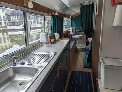 a kitchen with a sink and a window in an rv at New Horizon - A beautiful boat very conveniently located in Chelmsford City in Chelmsford
