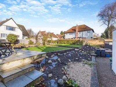 a garden with a stream in the yard of a house at Malting Cottage in Much Hadham