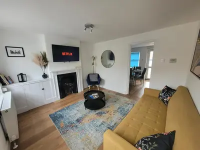a living room with a couch and a fire place at Little Oaks House - Historic Charm & Modern Comfort in Colchester by Catchpole Stays in Colchester