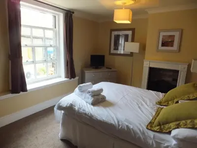 a bedroom with a bed with towels on it at The Red Lion, Stretham in Ely