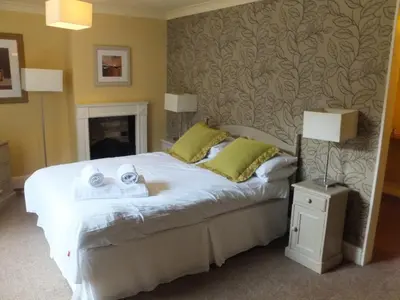 a bedroom with a bed with two towels on it at The Red Lion, Stretham in Ely