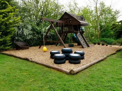 a playground with a play set in the grass at Deluxe 2 Bed Versace HotTub SkyTV in Saffron Walden
