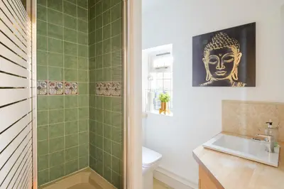 a bathroom with a shower and a toilet and a sink at Deluxe 2 Bed Versace HotTub SkyTV in Saffron Walden