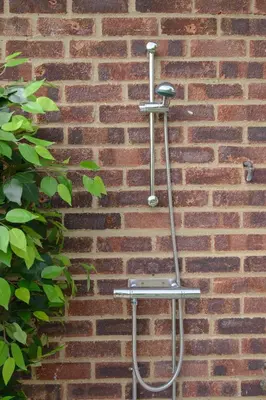 a metal towel rack on a brick wall at Deluxe 2 3 Bed HotTub SkyTV in Saffron Walden