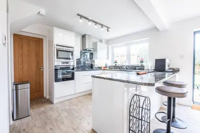 a kitchen with white cabinets and a counter top at 111 Front Street, Orford in Woodbridge
