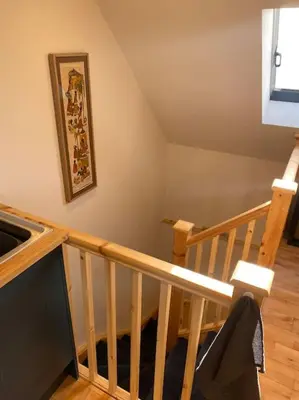 a room with a staircase with a picture on the wall at The Cartlodge, Debenham in Debenham