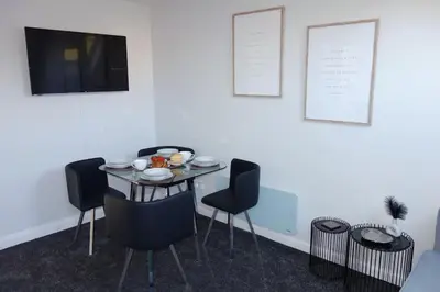 a dining room with a table and four chairs at Tulip Place in Chelmsford