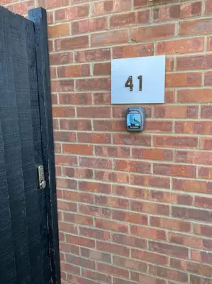 a brick wall with a number sign on it at Comfortable 3 bed house in Chelmsford in Chelmsford