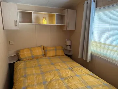 a small bed in a small room with a window at CaSa VistA - Holiday Home On The Beach in Clacton-on-Sea