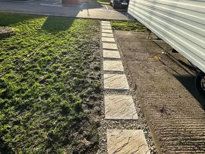 a stone walkway next to a house at CaSa VistA - Holiday Home On The Beach in Clacton-on-Sea