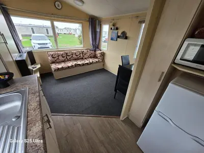 a small room with a couch and a window at CaSa VistA - Holiday Home On The Beach in Clacton-on-Sea