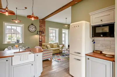 a kitchen with a white refrigerator and a living room at 2 Bed in Blythburgh oc-t27735 in Blyford