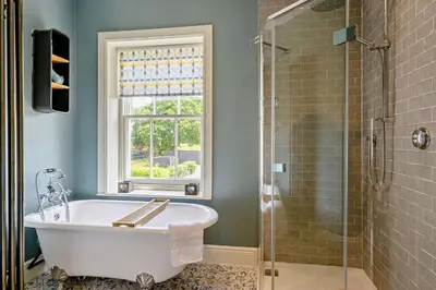 a bathroom with a bath tub and a window at 2 Bed in Blythburgh oc-t27735 in Blyford