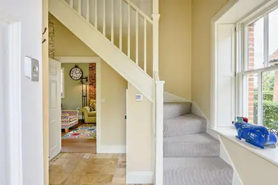 a hallway of a home with stairs and a window at 2 Bed in Blythburgh oc-t27735 in Blyford