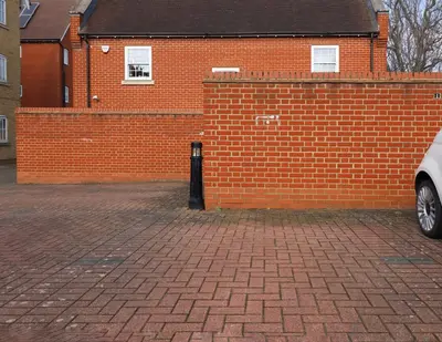 a red brick building with a brick parking lot at Hythe Hill Home in Colchester