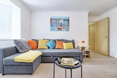 a living room with a couch and a table at Hythe Hill Home in Colchester