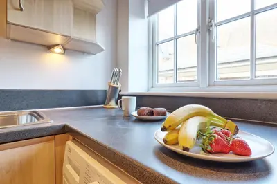 a plate of bananas and strawberries on a kitchen counter at Hythe Hill Home in Colchester