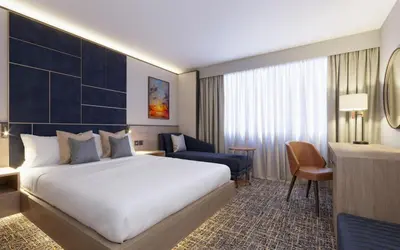 a hotel room with a bed and a desk at Delta Hotels by Marriott Colchester in Colchester