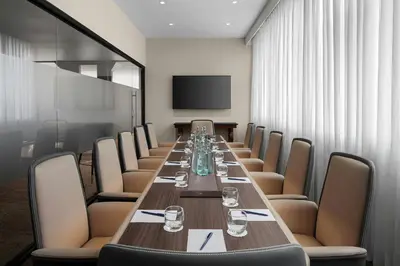 a conference room with a long table and chairs at Delta Hotels by Marriott Colchester in Colchester