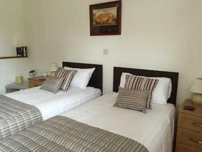 two beds sitting next to each other in a bedroom at Puttocks Farm in Great Dunmow