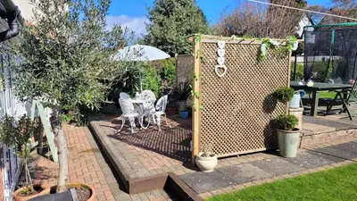 a garden with a fence and a table and chairs at Mulberry Annexe in Felixstowe