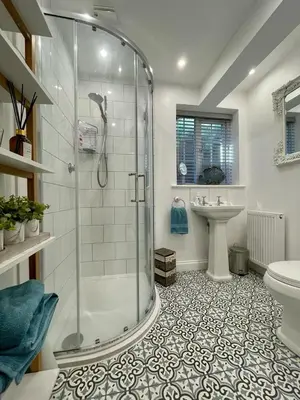 a bathroom with a shower and a toilet and a sink at Mulberry Annexe in Felixstowe