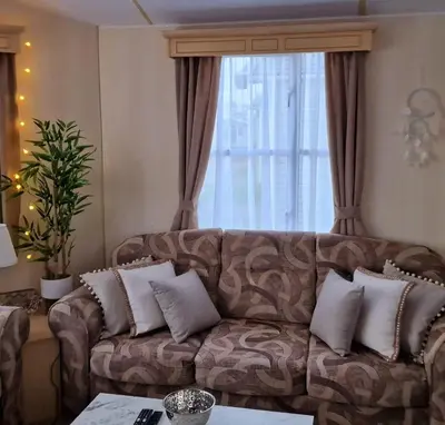 a living room with a couch and a window at Sunshine Atlas Glamping Retreat in Jaywick Sands