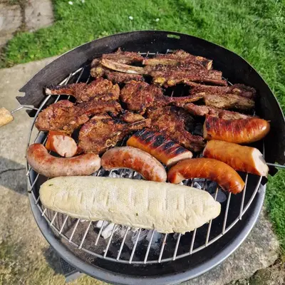 a grill with a bunch of meat and sausages at Sunshine Atlas Glamping Retreat in Jaywick Sands