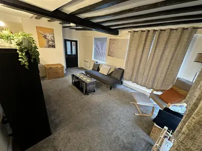 a living room with a couch and a table at Apartment - Sleeps 2 - Parking - WiFi in Colchester