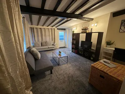 a living room with a couch and a tv at Apartment - Sleeps 2 - Parking - WiFi in Colchester