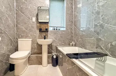 a bathroom with a toilet and a sink and a tub at Welcome to Northview House Stylish 4 Bedroom Home in Southend by Jesswood Properties Contractors Corporates Relocation Stays Long Stays Welcome in Southend-on-Sea