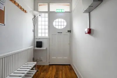 a hallway with a white door and a window at Welcome to Northview House Stylish 4 Bedroom Home in Southend by Jesswood Properties Contractors Corporates Relocation Stays Long Stays Welcome in Southend-on-Sea