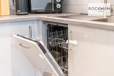 a dog in a dishwasher in a kitchen at Royal Oak Apartments 1 - Free Van Parking - 2 Bedroom Apartment - 2 bathrooms - Sleeps 6 - Perfect for Contractors - Fast Wi-fi in Brentwood