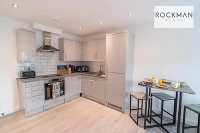 a kitchen with white cabinets and a counter top at Royal Oak Apartments 1 - Free Van Parking - 2 Bedroom Apartment - 2 bathrooms - Sleeps 6 - Perfect for Contractors - Fast Wi-fi in Brentwood