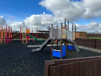 an empty playground with a slide and a slideintend at D34 Steeple Bay Caravan Site in Chelmsford