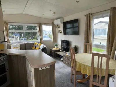 a small kitchen and living room in a caravan at D34 Steeple Bay Caravan Site in Chelmsford