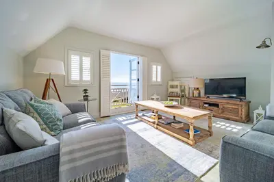 a living room with a couch and a table at 4 Truman Lodge in Thorpeness