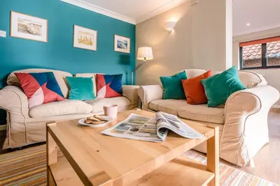 a living room with two couches and a coffee table at Melody Cottage in Aldeburgh