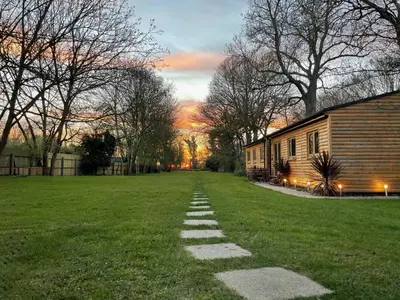 a stepping stone path in the grass next to a building at Kendall Lodge in Burwell