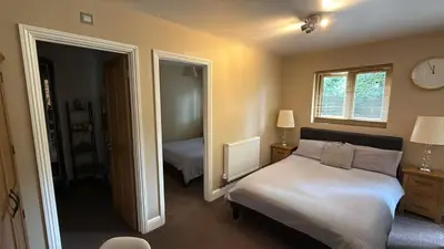 a bedroom with a bed and a mirror at Kendall Lodge in Burwell