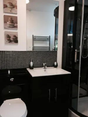 a bathroom with a toilet and a sink and a shower at Kendall Lodge in Burwell
